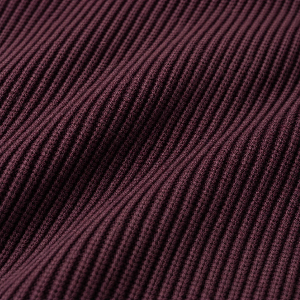 Close-up of the cardigan’s burgundy ribbed knit texture with vertically aligned ridges.