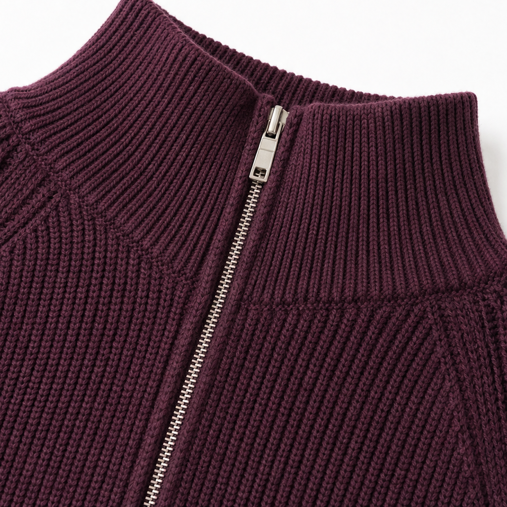 Detail of the cardigan’s raised ribbed collar and silver zipper at the upper front.