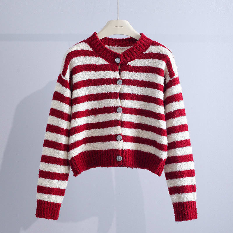 A striped cropped cardigan with a round neckline, button front, long sleeves, and ribbed trim hangs on a hanger._0