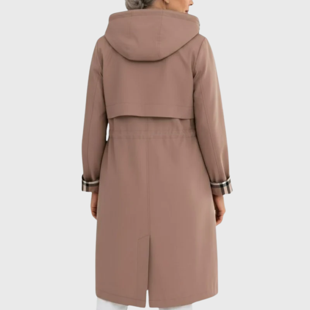 Woman wearing a longline hooded trench coat with zip front, drawstring waist, and patch pockets in a neutral tone._2