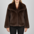 Woman wearing a cropped jacket with an oversized collar and soft, plush texture paired with black pants_0