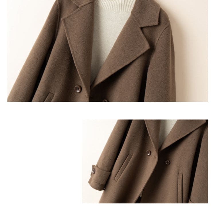 A tailored double breasted coat with notched lapels, front pockets, and buttoned cuff tabs displayed on a mannequin._9