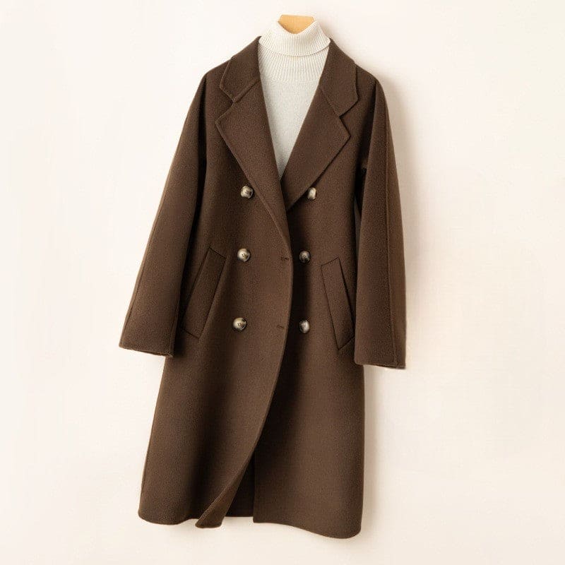 A double breasted longline coat with notched lapels and side welt pockets displayed on a mannequin._0