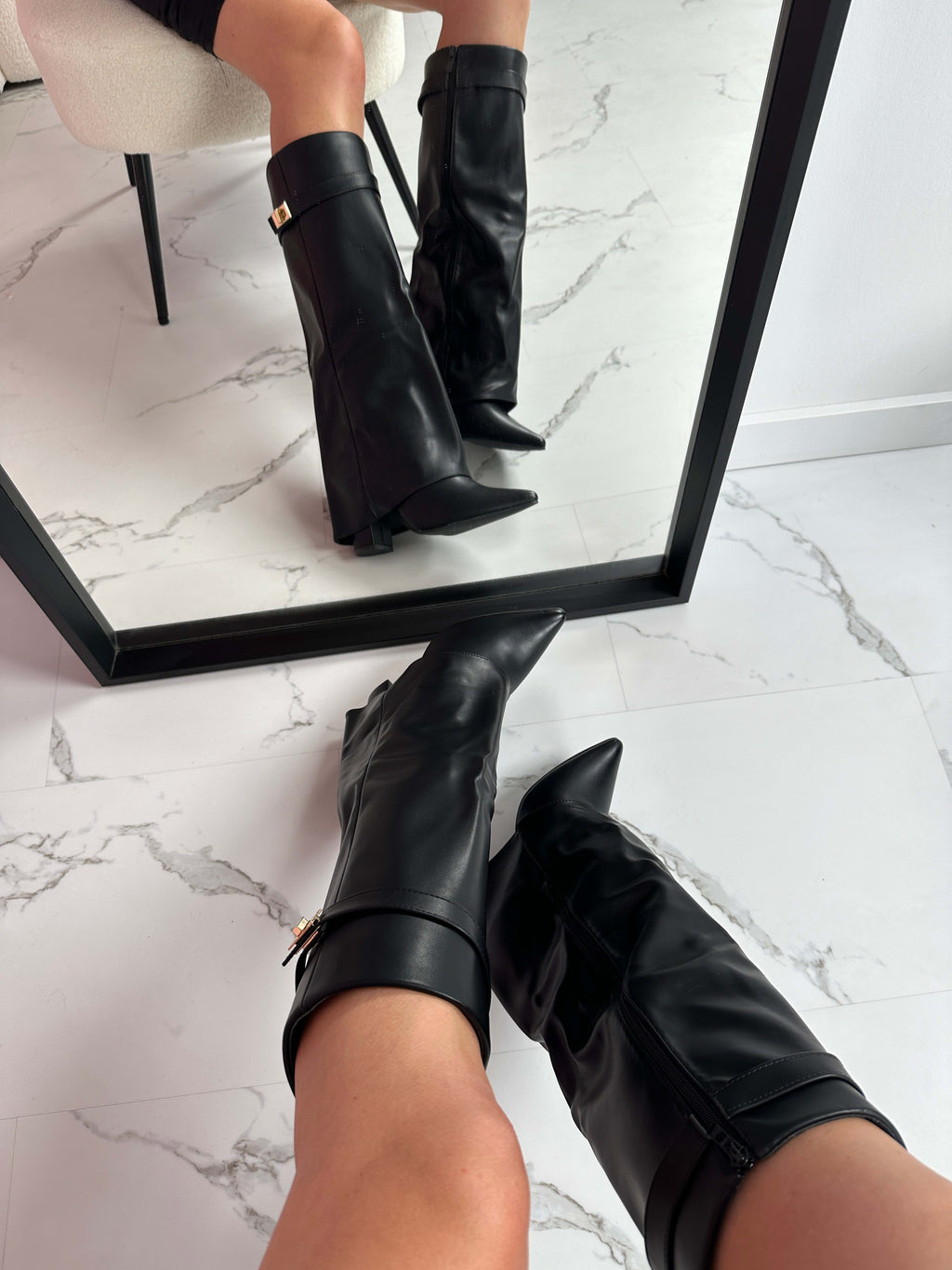 Woman wearing mid-calf boots with pointed toe, block heel, and decorative turnlock hardware at ankle._1