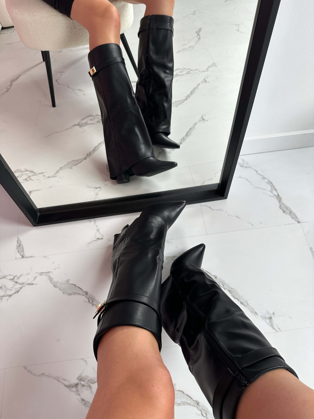 Woman wearing mid-calf boots with pointed toe, block heel, and decorative turnlock hardware at ankle._1