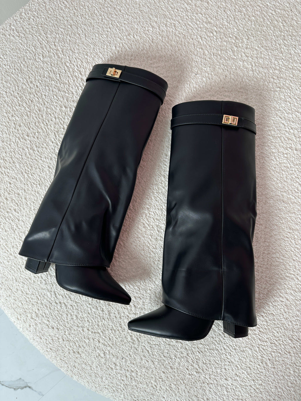 Woman wearing mid-calf boots with pointed toe, block heel, and decorative turnlock hardware at ankle._4