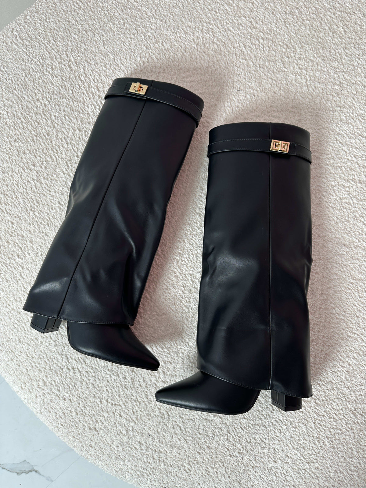 Woman wearing mid-calf boots with pointed toe, block heel, and decorative turnlock hardware at ankle._4