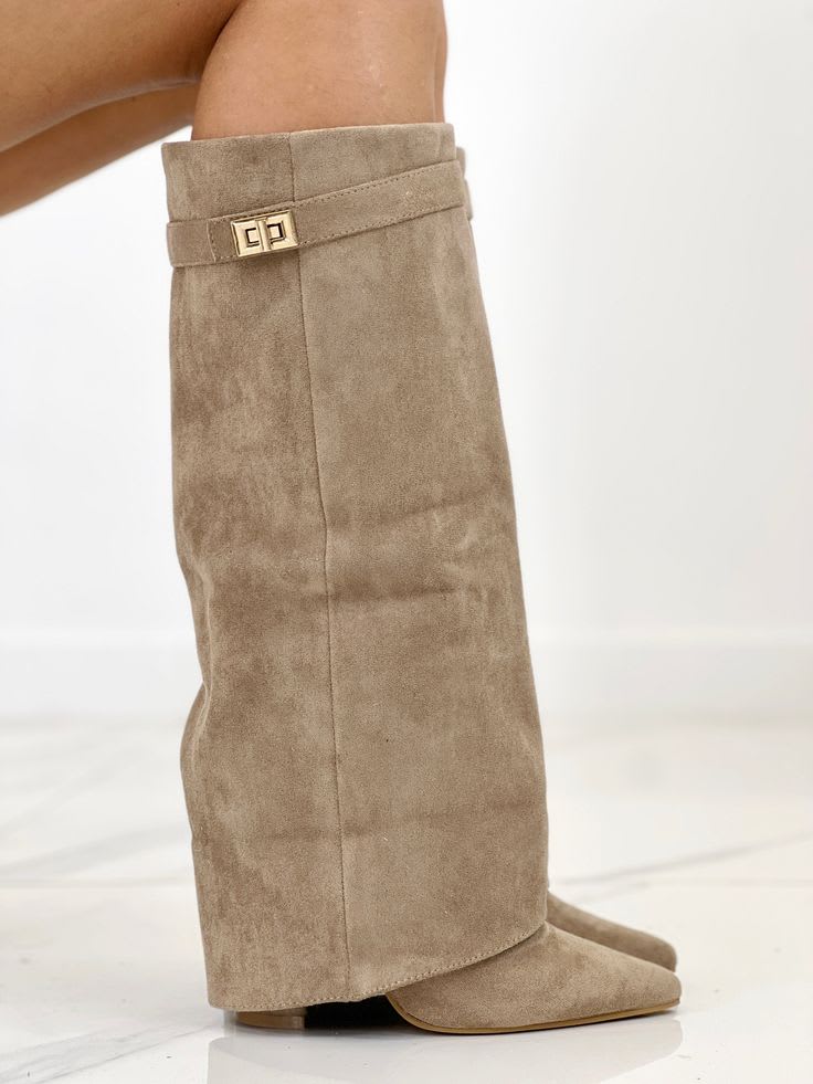 Woman wearing mid-calf boots with pointed toe, block heel, and decorative turnlock hardware at ankle._5
