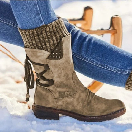 Mid-calf boots with lace-up back detail and studded accents worn with jeans and knit socks._0