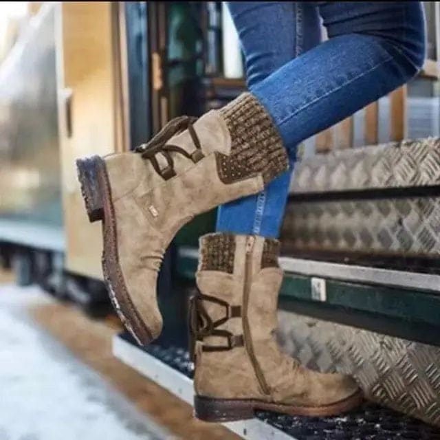 Mid-calf boots with lace-up back detail and studded accents worn with jeans and knit socks._1