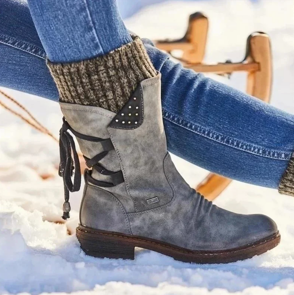 Mid-calf boots with lace-up back detail and studded accents worn with jeans and knit socks._3