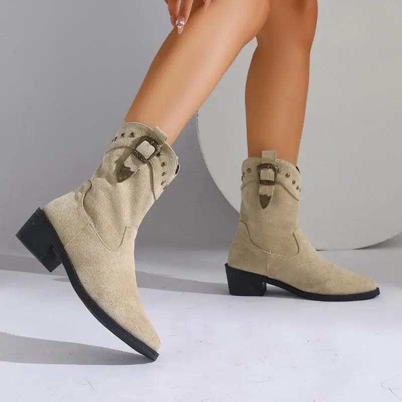 Woman wearing mid-calf boots with buckle strap and stud detailing, paired with bare legs._1
