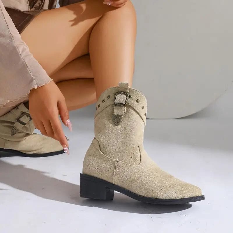Woman wearing mid-calf boots with buckle strap and stud detailing, paired with bare legs._2