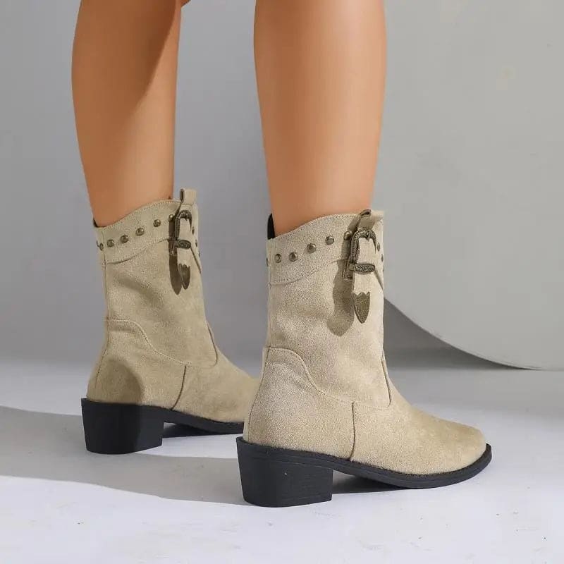 Woman wearing mid-calf boots with buckle strap and stud detailing, paired with bare legs._3