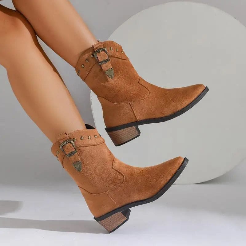 Woman wearing mid-calf boots with buckle strap and stud detailing, paired with bare legs._5
