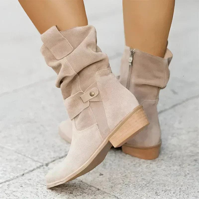 Woman wearing mid-calf boots with wrap straps and a low block heel._0