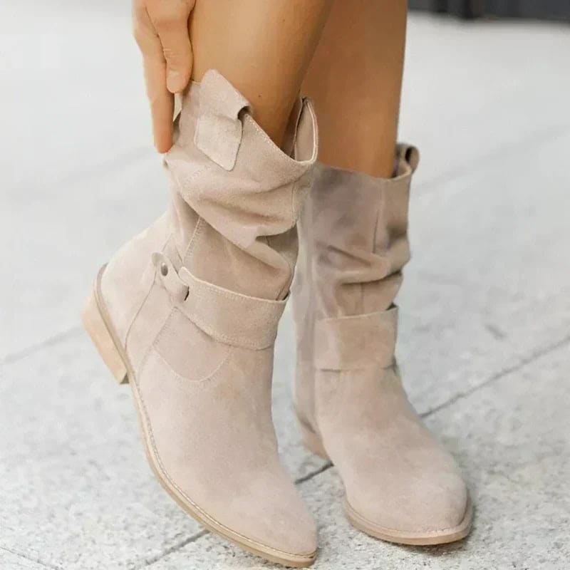 Woman wearing mid-calf boots with wrap straps and a low block heel._1