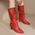 Woman wearing red mid-calf slouch boots with pointed toe and sculpted heel._0