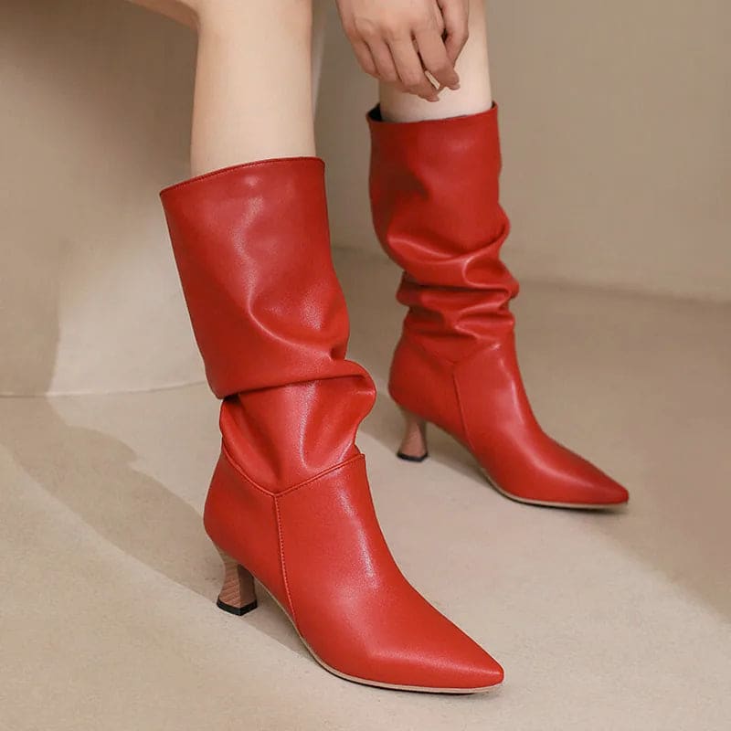 Woman wearing red mid-calf slouch boots with pointed toe and sculpted heel._0