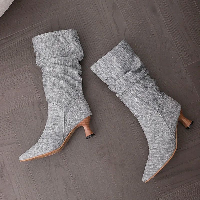 Woman wearing red mid-calf slouch boots with pointed toe and sculpted heel._11