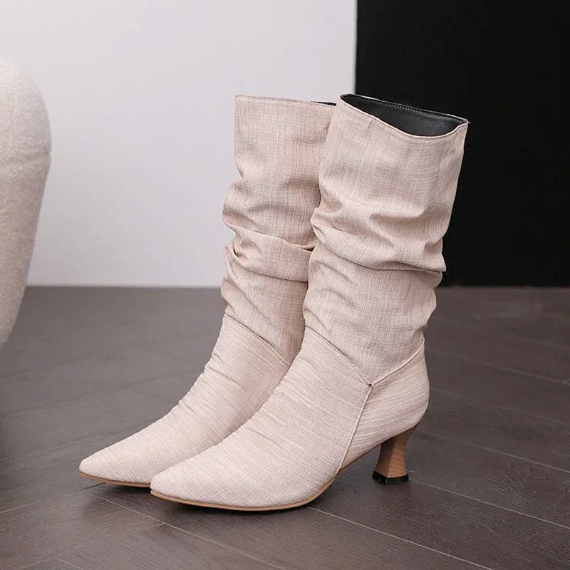 Woman wearing red mid-calf slouch boots with pointed toe and sculpted heel._14
