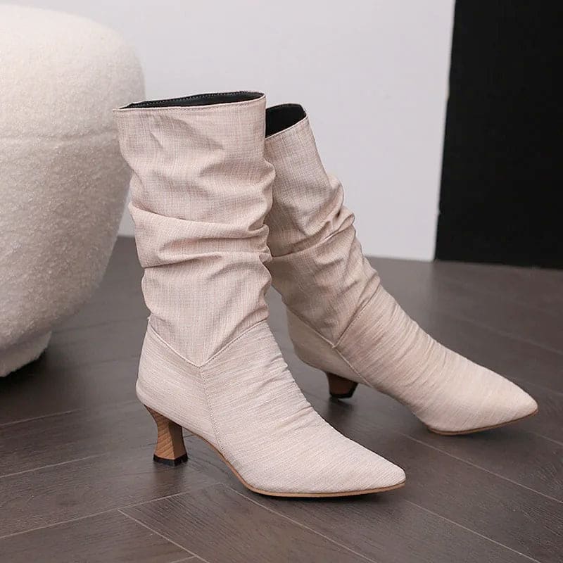 Woman wearing red mid-calf slouch boots with pointed toe and sculpted heel._15