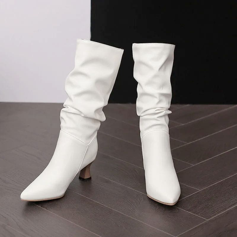 Woman wearing red mid-calf slouch boots with pointed toe and sculpted heel._16