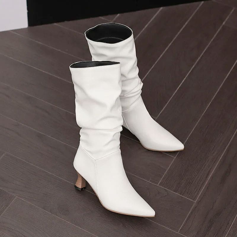 Woman wearing red mid-calf slouch boots with pointed toe and sculpted heel._17