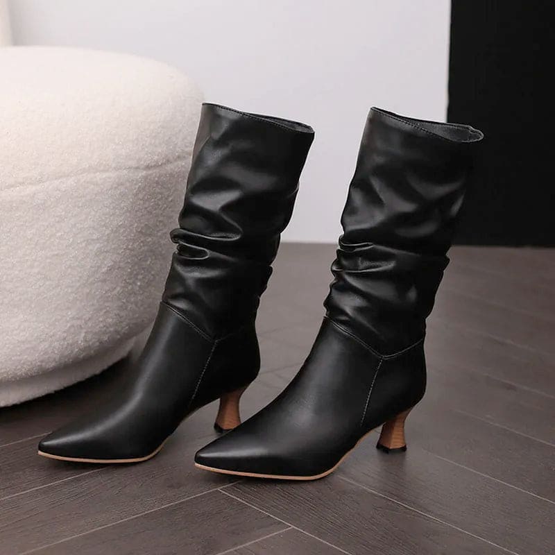 Woman wearing red mid-calf slouch boots with pointed toe and sculpted heel._24