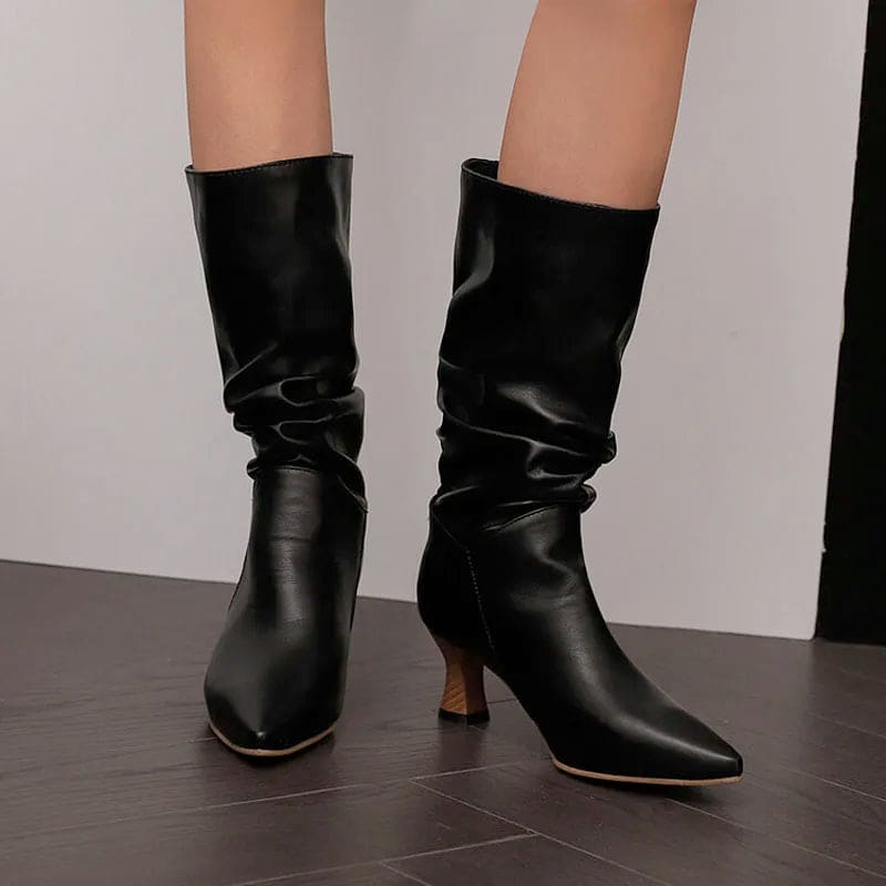 Woman wearing red mid-calf slouch boots with pointed toe and sculpted heel._25