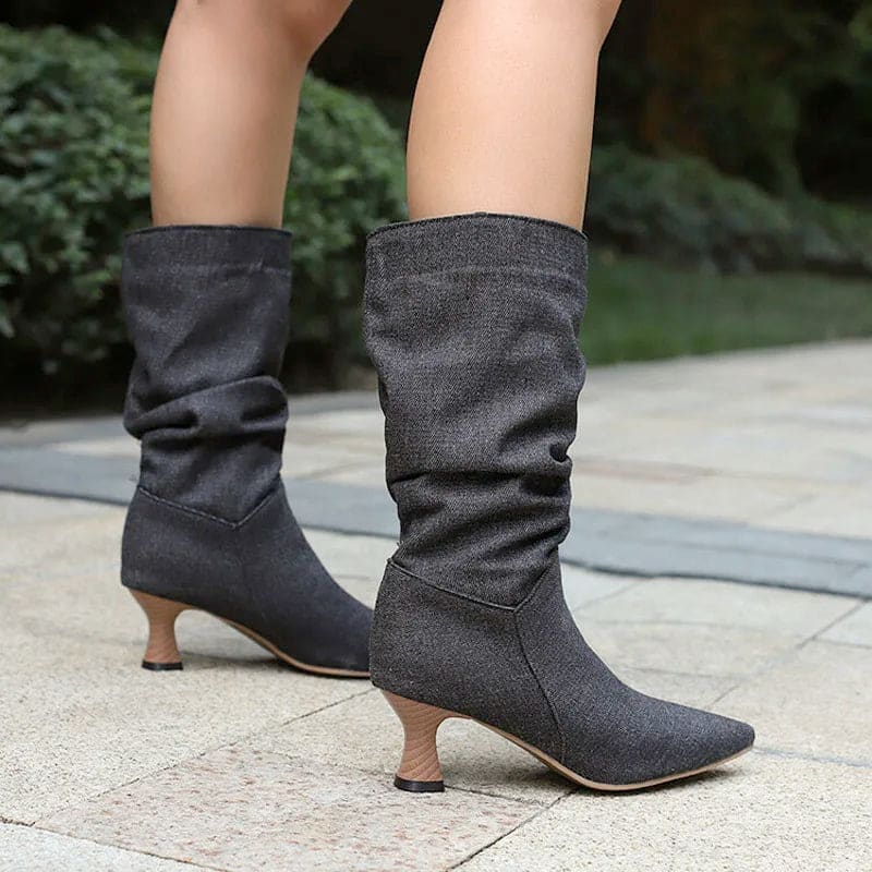 Woman wearing red mid-calf slouch boots with pointed toe and sculpted heel._29