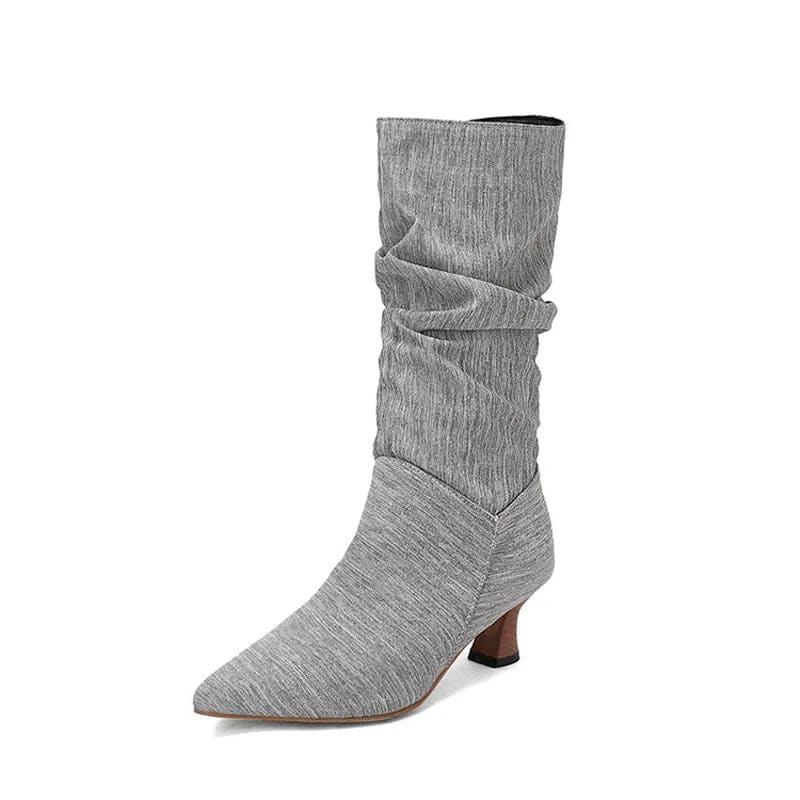 Woman wearing red mid-calf slouch boots with pointed toe and sculpted heel._31