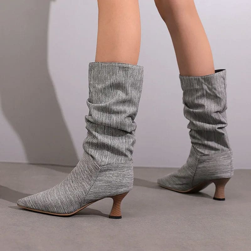 Woman wearing red mid-calf slouch boots with pointed toe and sculpted heel._9