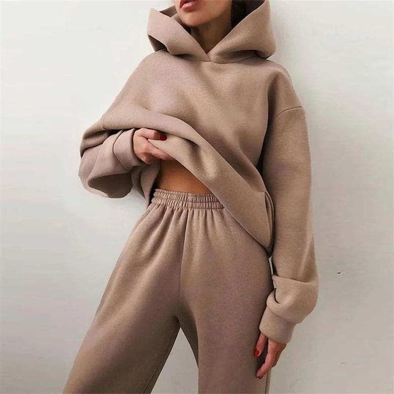 Model wearing a relaxed hooded sweatshirt and matching jogger pants._0