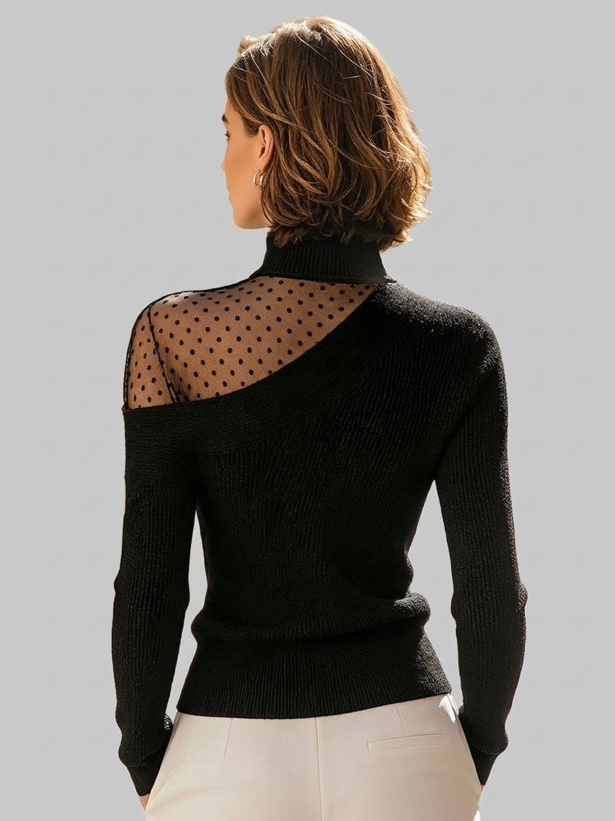 Woman wearing a fitted black ribbed turtleneck sweater with an asymmetric shoulder cutout covered in sheer black polka dot mesh, paired with cream trousers._1