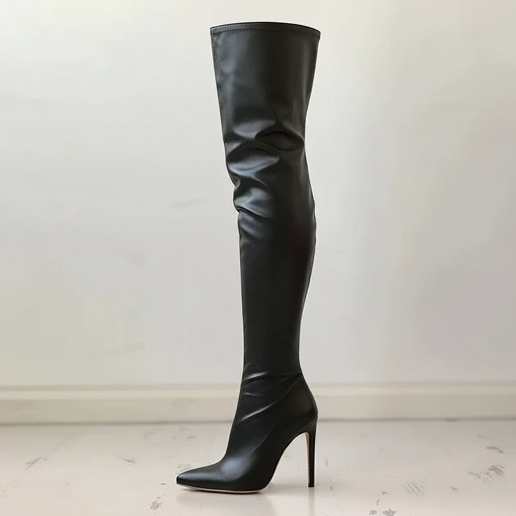 Single black over-the-knee boot shown in profile with a pointed toe, tall shaft, and slim stiletto heel.