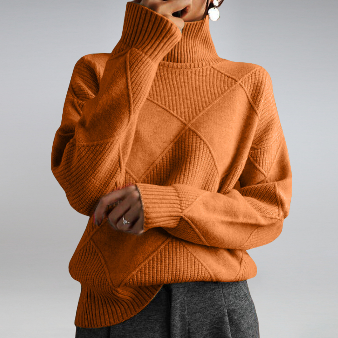 Woman wearing an oversized turtleneck sweater in warm rust orange with ribbed detailing and a relaxed fit, paired with dark trousers._0