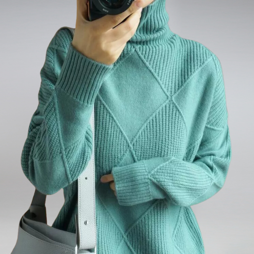 Woman wearing an oversized turtleneck sweater in warm rust orange with ribbed detailing and a relaxed fit, paired with dark trousers._4