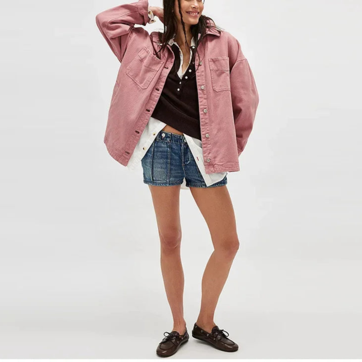 Woman wearing an oversized button-front jacket with chest pockets and a relaxed silhouette, styled over a white top and pants._12