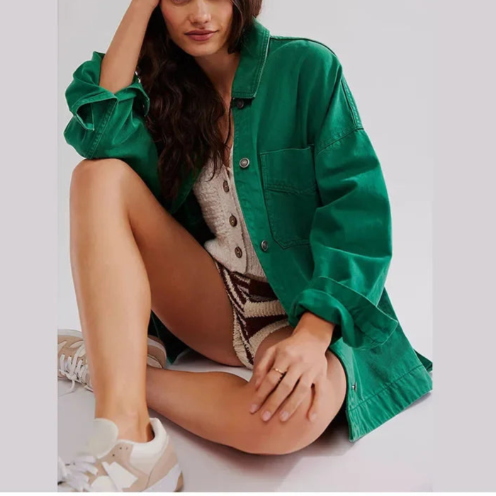 Woman wearing an oversized button-front jacket with chest pockets and a relaxed silhouette, styled over a white top and pants._16