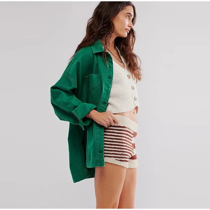 Woman wearing an oversized button-front jacket with chest pockets and a relaxed silhouette, styled over a white top and pants._19