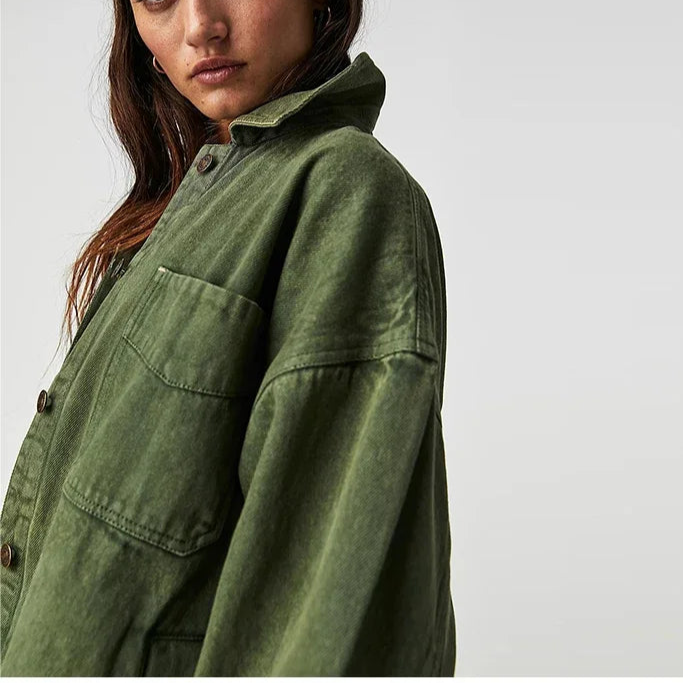 Woman wearing an oversized button-front jacket with chest pockets and a relaxed silhouette, styled over a white top and pants._22
