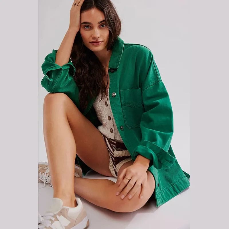 Woman wearing an oversized button-front jacket with chest pockets and a relaxed silhouette, styled over a white top and pants._27