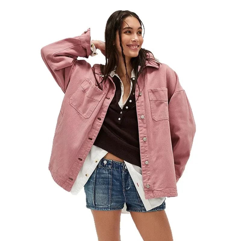 Woman wearing an oversized button-front jacket with chest pockets and a relaxed silhouette, styled over a white top and pants._28