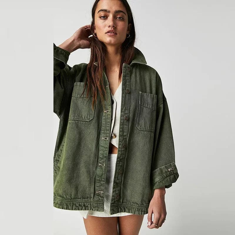 Woman wearing an oversized button-front jacket with chest pockets and a relaxed silhouette, styled over a white top and pants._30