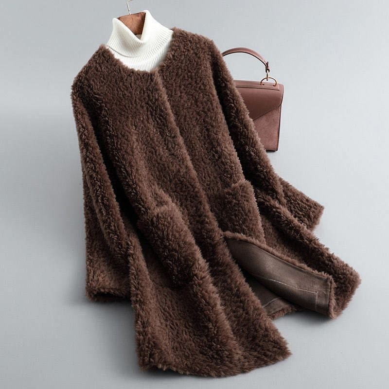 Chocolate brown plush longline coat shown open with a contrasting white ribbed turtleneck underneath and brown lining at the front.