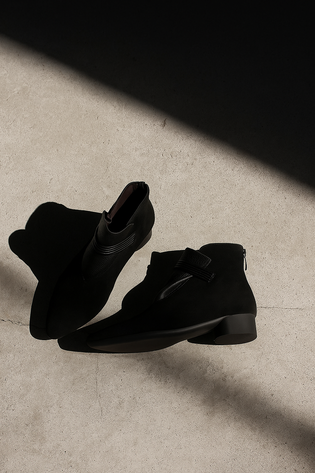 A side view of a pointed toe ankle boot with a decorative strap detail and low block heel._10