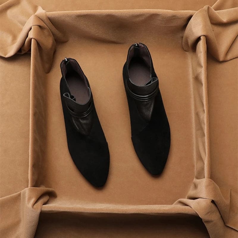 A side view of a pointed toe ankle boot with a decorative strap detail and low block heel._14