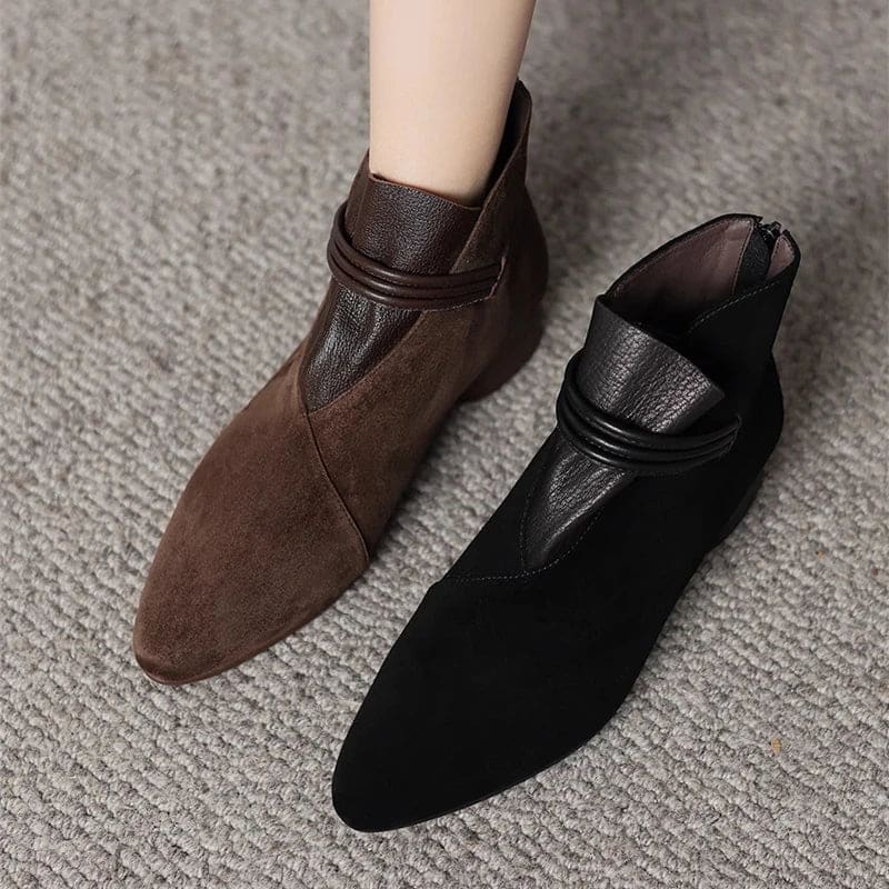 A side view of a pointed toe ankle boot with a decorative strap detail and low block heel._18