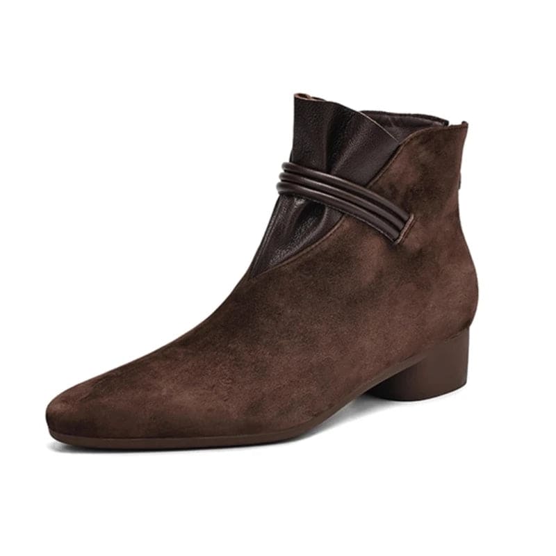 A side view of a pointed toe ankle boot with a decorative strap detail and low block heel._27
